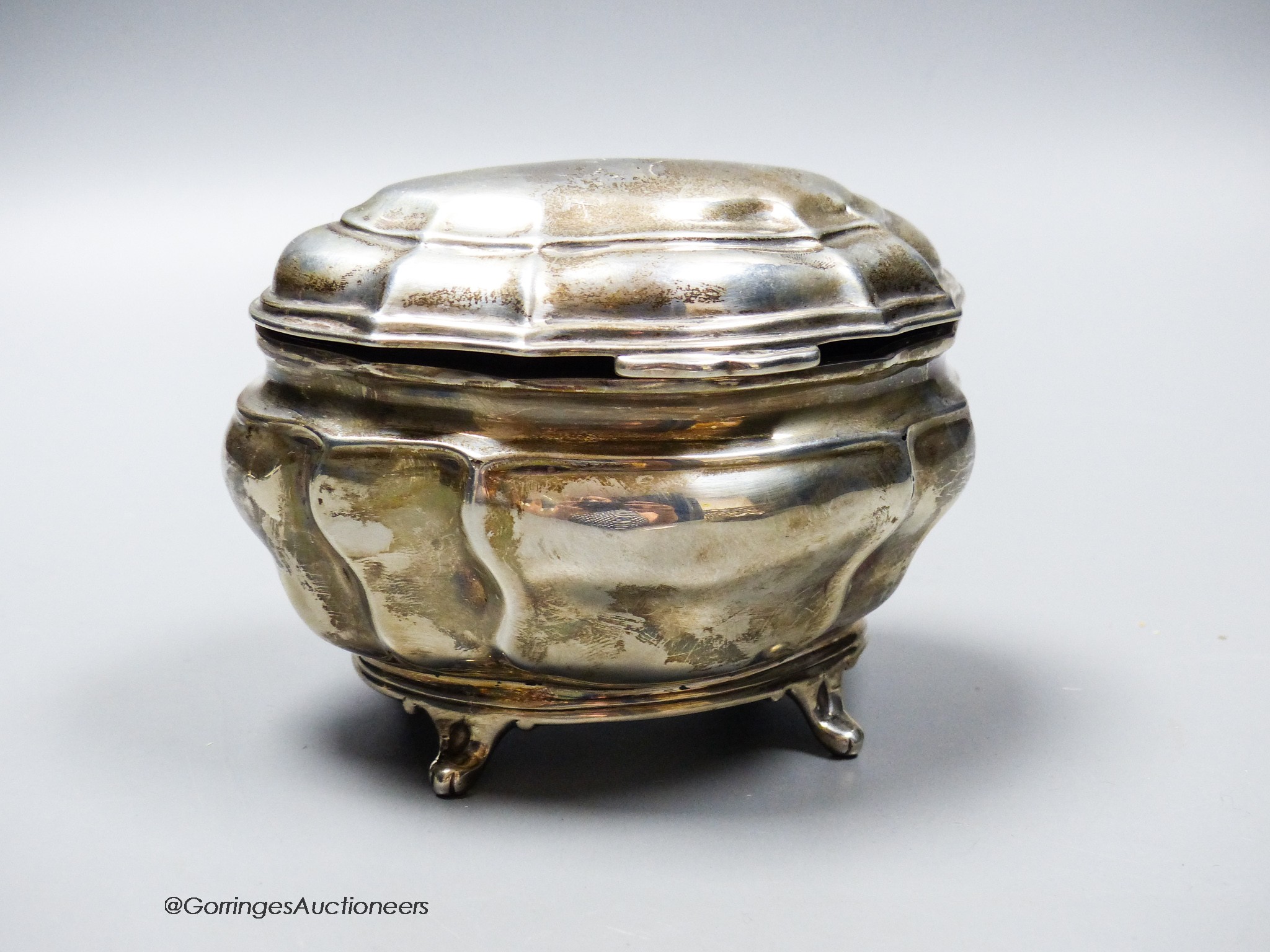 An Edwardian silver shaped oval tea caddy, Charles Stuart Harris Ltd, London, 1902, length 13.4cm, 7.5oz.